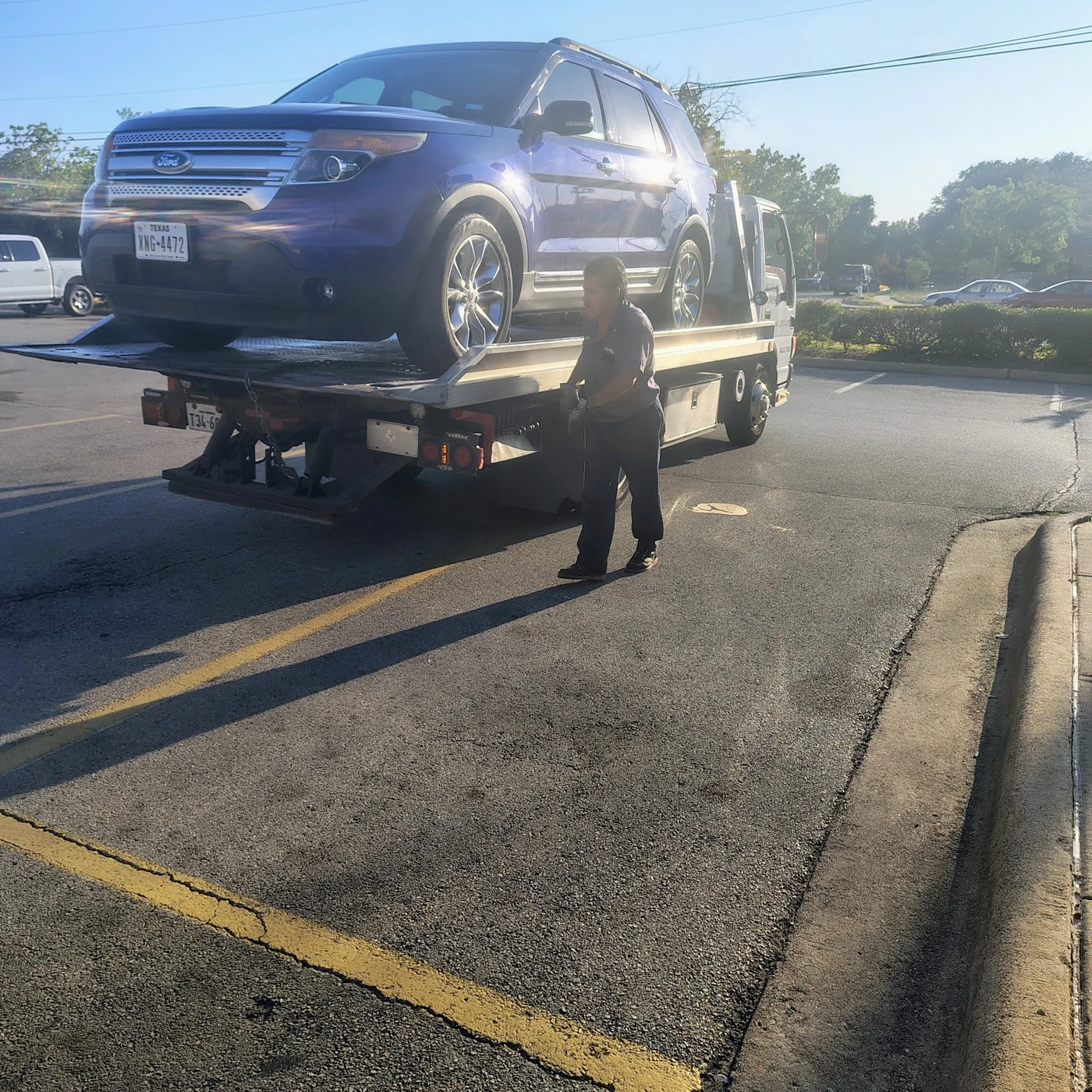 Blue vehicle loaded onto the tow truck and ready for transport