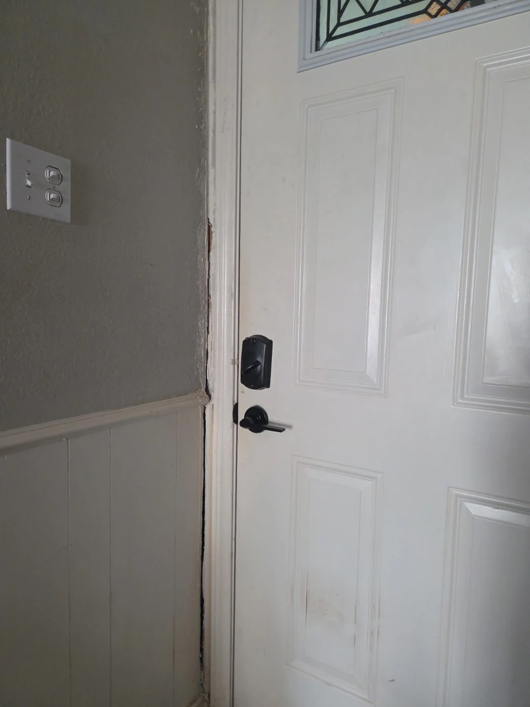 Damaged entry-door frame before repair in DeSoto