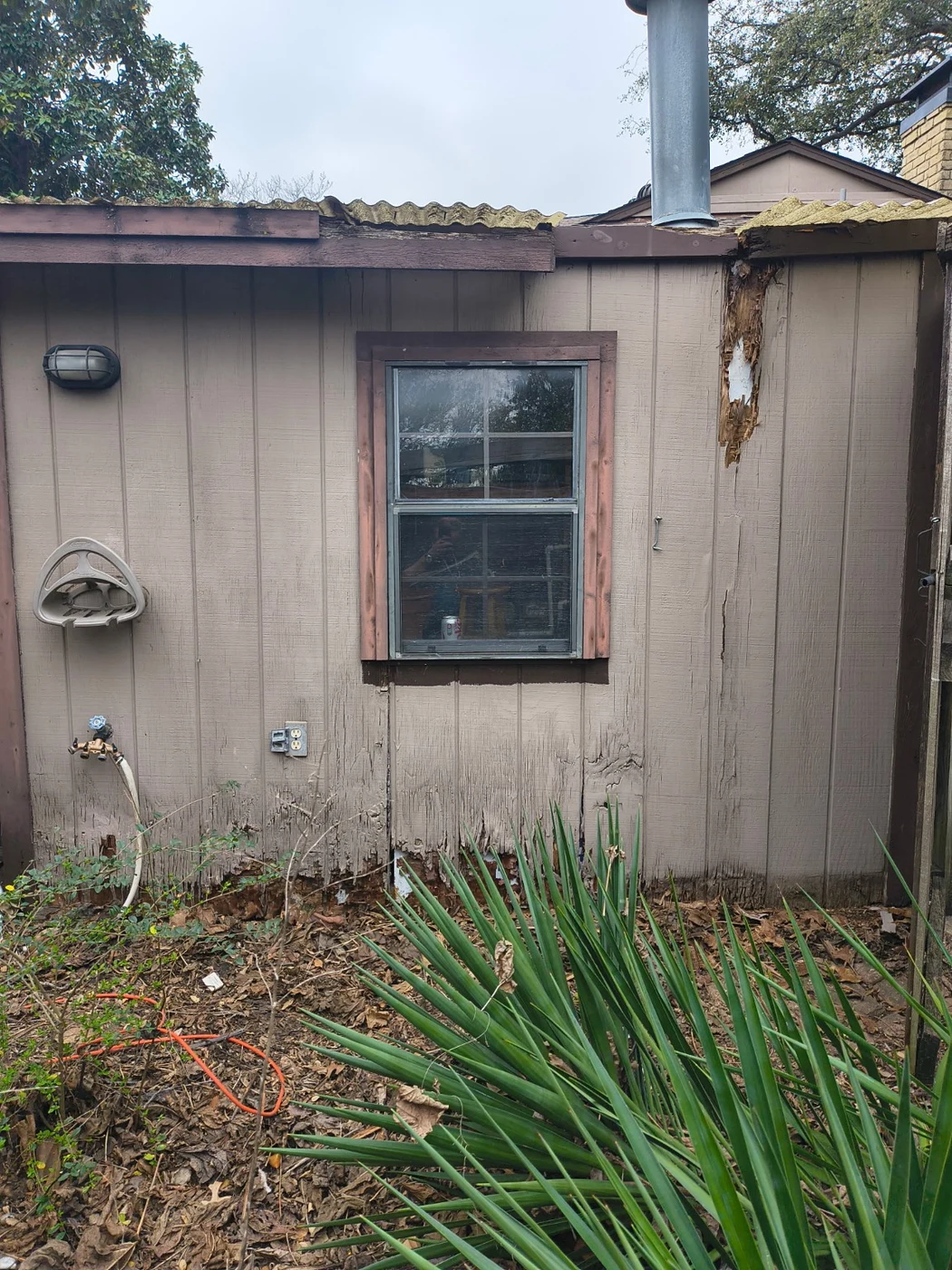 Exterior wall and window before the Garland repair and refresh