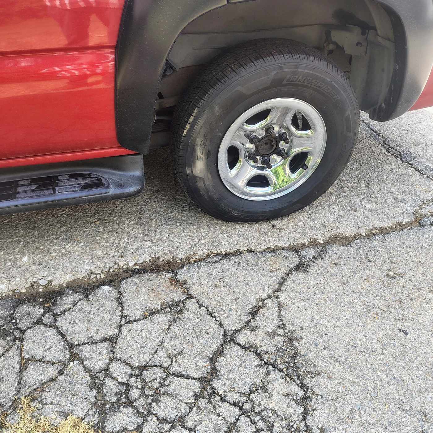 Spare wheel installed on the red pickup after the tire change