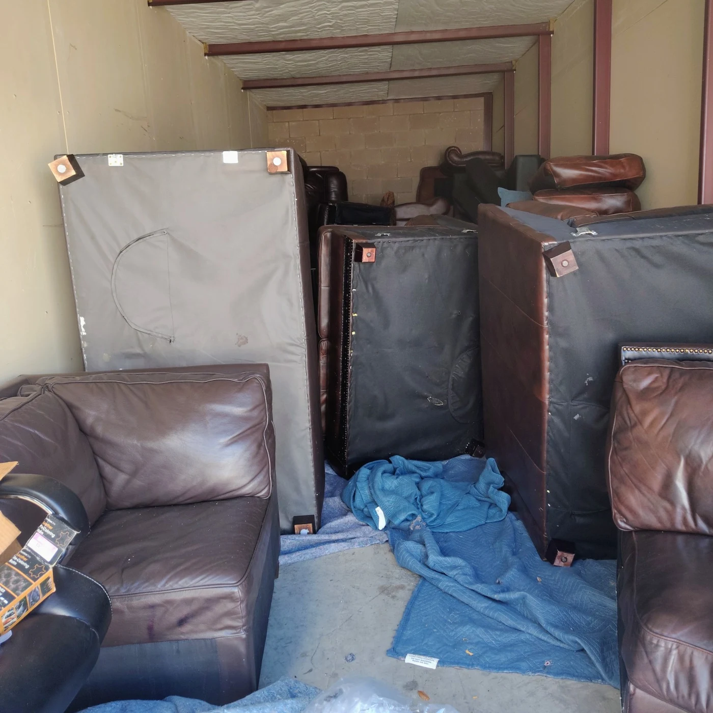 Furniture and belongings inside an Irving storage unit before clearing