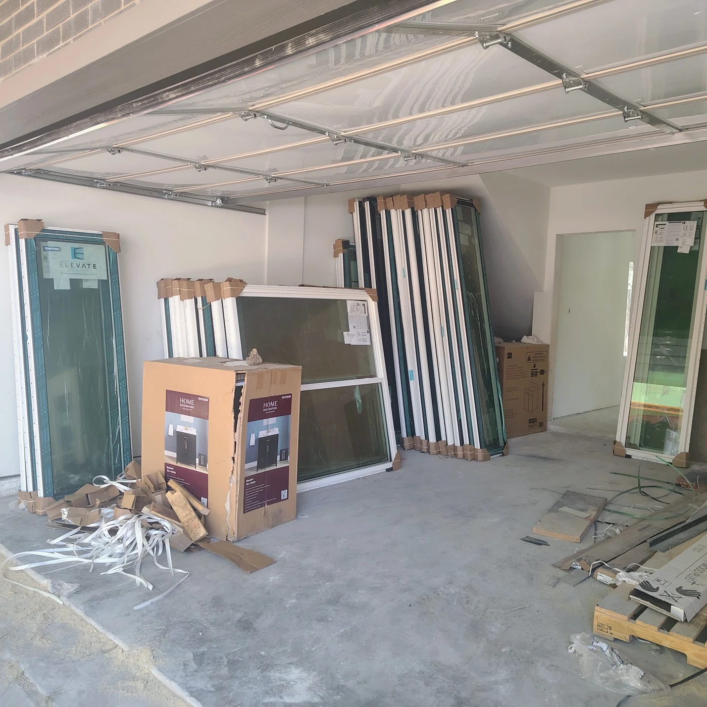 Unloaded windows arranged inside the construction site garage