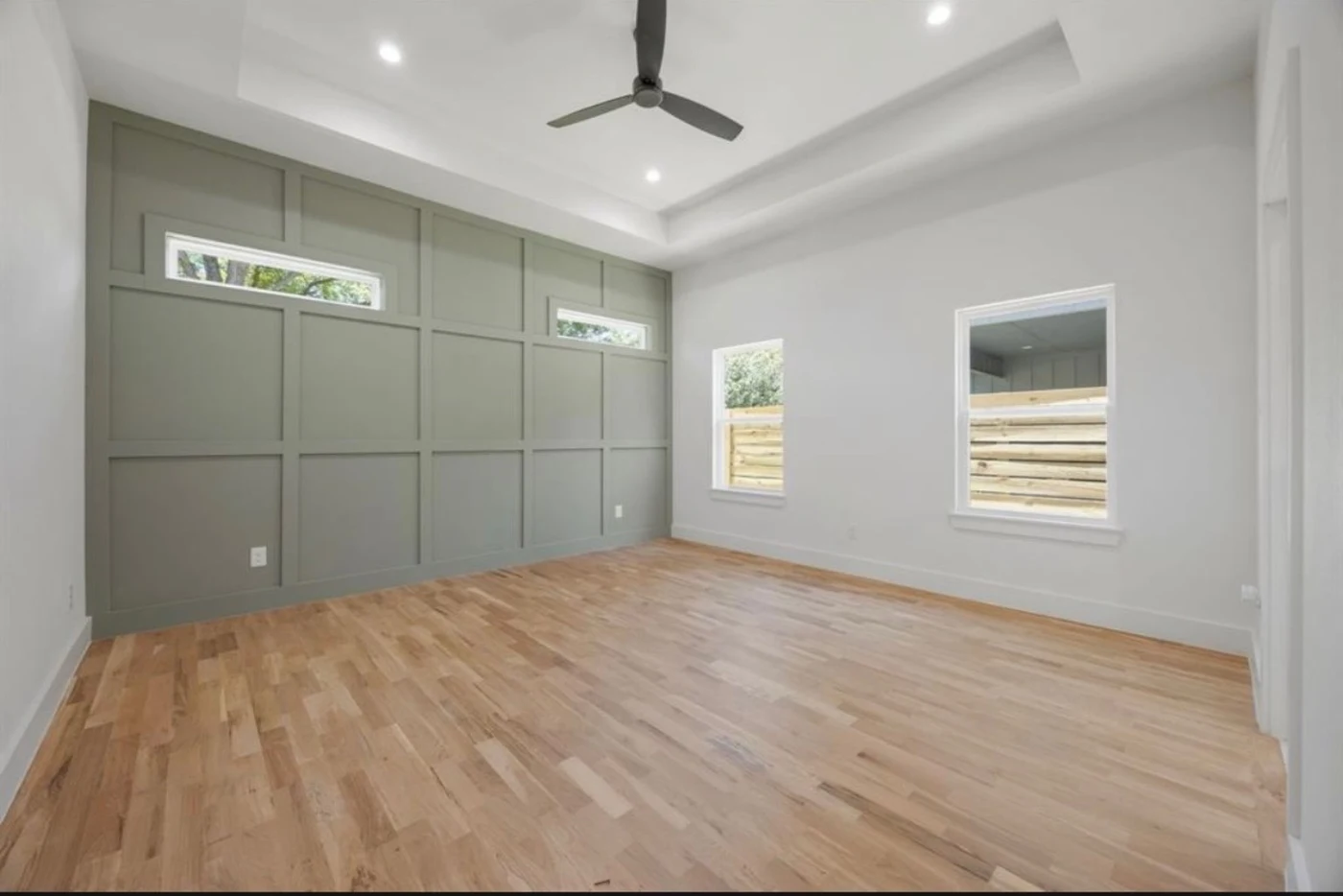 Bedroom and green paneled accent wall before repainting in downtown Dallas